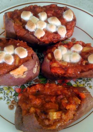 A picture of Apple and pecan stuffed /baked sweet potatoes.