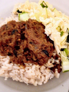 A picture of Cinnamon-Coconut flavored local(ofada) rice with goat meat stew.