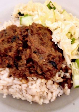 A picture of Cinnamon-Coconut flavored local(ofada) rice with goat meat stew.