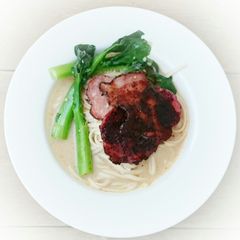 A picture of Udon Noodle With Choy Sum And Black Pepper Ham In Milk Soup.