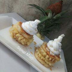 A picture of Pineapple pancakes with maple syrup.