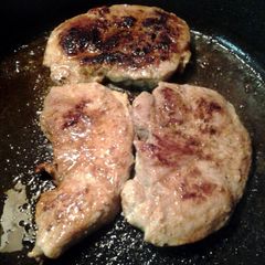 A picture of pan fried porkchops.