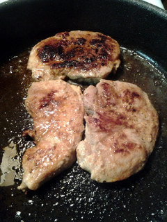A picture of pan fried porkchops.