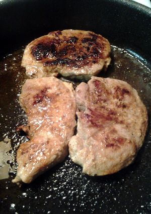 A picture of pan fried porkchops.