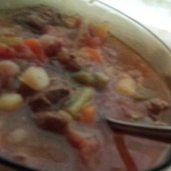 A picture of Spicy veggie soup with beef stew meat.