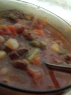 A picture of Spicy veggie soup with beef stew meat.