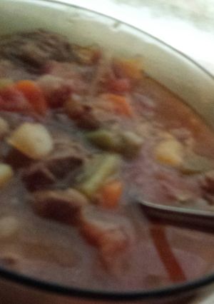 A picture of Spicy veggie soup with beef stew meat.