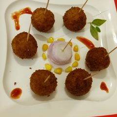 A picture of Cheesy poha lollipops.