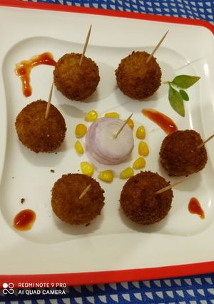 A picture of Cheesy poha lollipops.