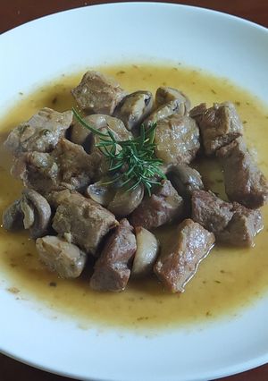 Una foto de Lagarto ibérico con vino blanco y champiñones