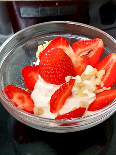 A picture of My Healthy Dessert. Greek yogurt & Sliced fresh 🍓+ Nuts.