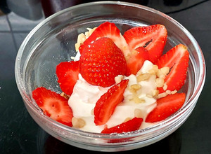 A picture of My Healthy Dessert. Greek yogurt & Sliced fresh 🍓+ Nuts.