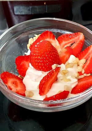A picture of My Healthy Dessert. Greek yogurt & Sliced fresh 🍓+ Nuts.