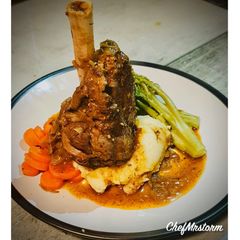 A picture of Slow Cooked Lamb Shank with Garlic-Spring Onion Buttery Mashed Potatoes and Red Wine+Onion Jus.