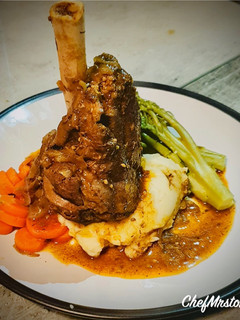 A picture of Slow Cooked Lamb Shank with Garlic-Spring Onion Buttery Mashed Potatoes and Red Wine+Onion Jus.