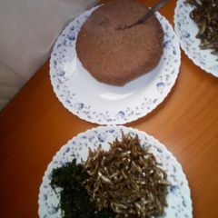 A picture of Brown ugali,omena and greens.