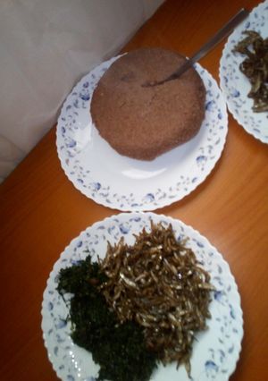 A picture of Brown ugali,omena and greens.