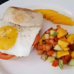 A picture of Sunny side-up muffin with mango salad.