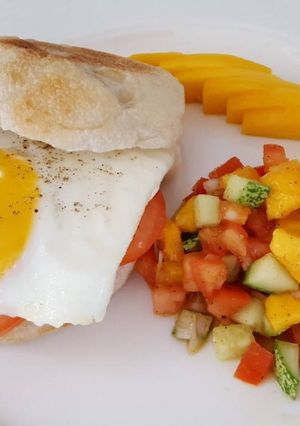 A picture of Sunny side-up muffin with mango salad.