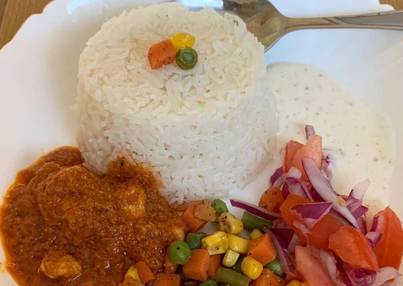 Garlic rice with gravy chicken and veggies and salad raita