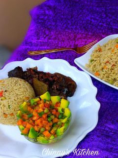 A picture of Coconut rice, avocado salad and fried goat meat.