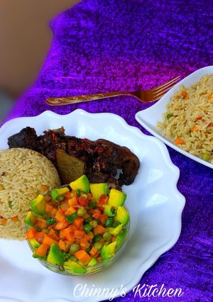 A picture of Coconut rice, avocado salad and fried goat meat.