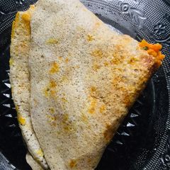 A picture of Carrot masala dosa / stuffed idly.