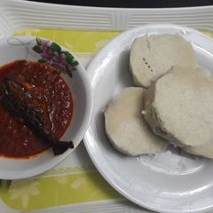 A picture of Boiled yam with tomato stew and titus fish.
