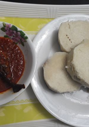 A picture of Boiled yam with tomato stew and titus fish.