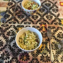 A picture of Pasta with zucchini and dried tomatoes.