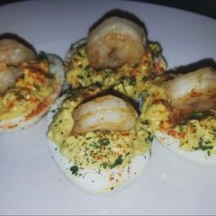 A picture of Devil eggs with shrimp.