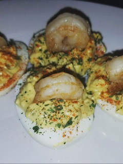 A picture of Devil eggs with shrimp.