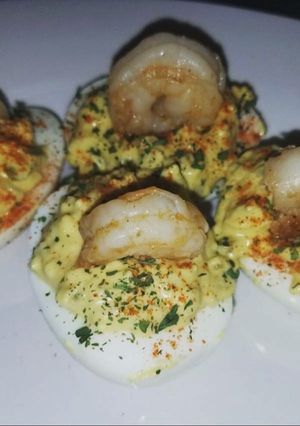 A picture of Devil eggs with shrimp.