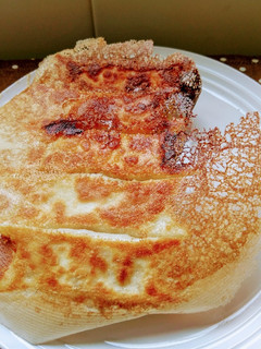 A picture of Pan-Fried Dumplings with Crispy Skirt.