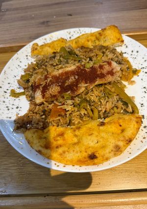 A picture of One Pot Steamed White Fish and Savory Rice with Roasted Garlic and Tomato Sauce.