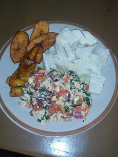 A picture of Fried plantain,voiled yam with vegetable egg sauce.