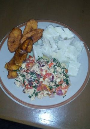 A picture of Fried plantain,voiled yam with vegetable egg sauce.