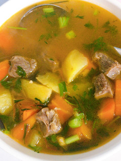 A picture of Beef stew with potatoes and carrots.