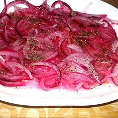 A picture of Pickled onions with black pepper.