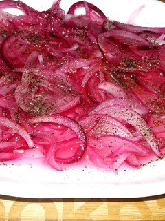 A picture of Pickled onions with black pepper.