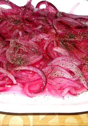A picture of Pickled onions with black pepper.