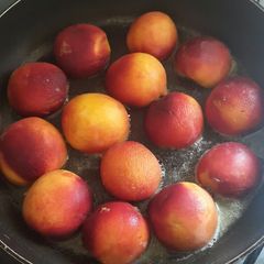 A picture of Grilled peaches with Dulce de leche mascapone cream.