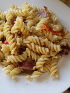 A picture of Pasta, bacon cheese and peppers.