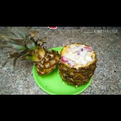 A picture of Fruit Chaat in pineapple bowl.