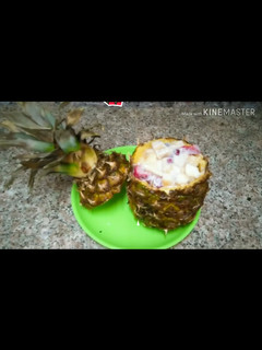 A picture of Fruit Chaat in pineapple bowl.