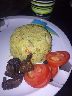 A picture of Vegetable Jolof rice with fried meat.
