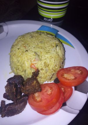 A picture of Vegetable Jolof rice with fried meat.