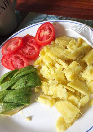 A picture of Boiled sweet potatoes with avocado and tomatoes.