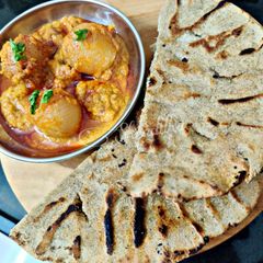 A picture of Onion curry with bajra rotla.