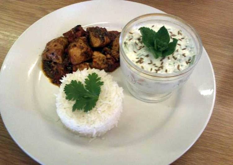 Recipe of Any-night-of-the-week Achar (eastern pickle) Chicken curry served with rice and a mint and cucumber raita.